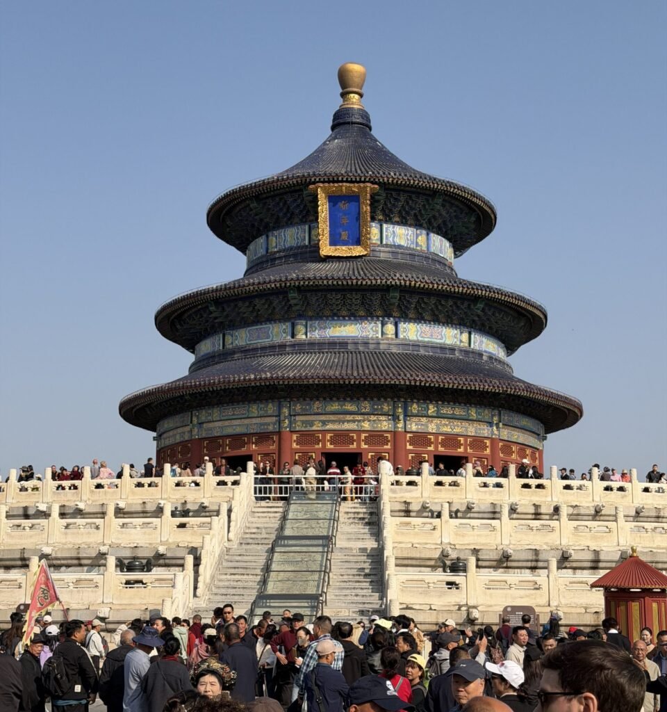 The round, triple-roofed Hall of Prayer for Good Harvests at the Temple of Heaven in Beijing, above white marble terraces with a crowd of visitors in front
